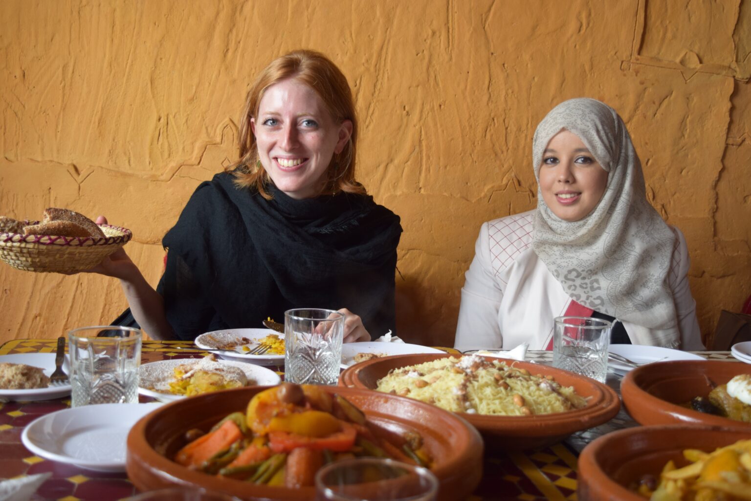 two girls at a table sharing food